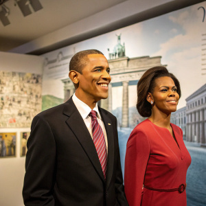 Barack and Michelle Obama's wax figures at Madame Tussauds Berlin. Displayed against a Berlin Wall backdrop.