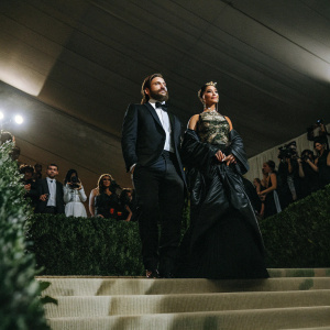 Jake Gyllenhaal and Rihanna at the Met Gala. Brightly lit auditorium with a star-studded crowd.