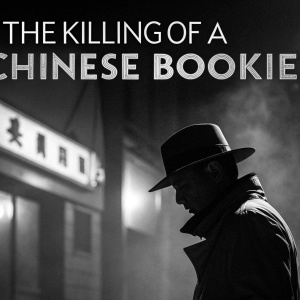 Promotional poster for 'The Killing of a Chinese Bookie'. Black and white image, showcasing a mysterious, shadowy figure in the foreground, set against a blurred, dark background. Title 'The Killing of a Chinese Bookie' in bold, retro font across the top, evoking classic film noir style with high contrast and dramatic shadows.