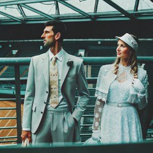 Novak Djokovic and Elena Rybakina standing at Wimbledon, dressed in formal attire. Golden tie and lace detailing