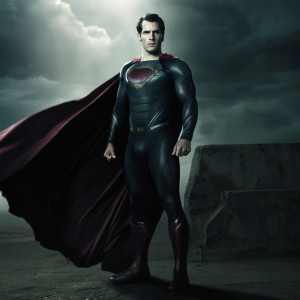 Henry Cavill as Superman. Muscular, iconic costume. Dark, dramatic backdrop with stormy clouds. Promotional photo.
