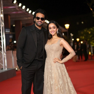 Prabhas and Shraddha Kapoor at the film festival. Prabhas, in black suit and shades. Shraddha Kapoor in a stunning beige lace gown. They pose together on the red carpet.
