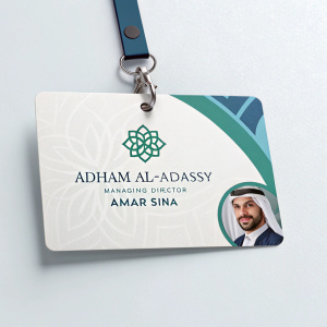 Business card of Adham Al-Adassy, Managing Director of Amar Sina. Modern design with logo and Arabic text. Light, neutral background.