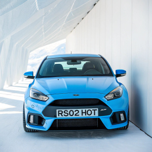 Ford Focus RS in stunning azure hue, featuring custom license plate 'RS02 HOT'. Displayed against a pristine white backdrop, highlighting its sleek design and premium detailing.