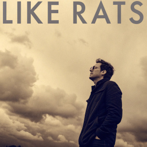 Album cover for 'Like Rats' by Mark Kozelek. Sepia-toned, moody image of a cloudy sky. Text 'LIKE RATS' in bold, modern font centered.