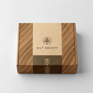 A minimalist packaging design for Kilt Society. Eco-friendly brown box with wood grain texture. Clear branding and Scottish theme.