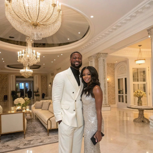 Dwyane Wade and Gabrielle Union at a luxurious home party. Exquisite interior design. Posh furniture, chandeliers, and lavish decorations.
