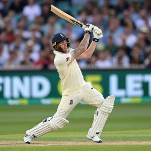 Ben Stokes mid-swing, cricket stadium backdrop, blurred crowd and green field in the background, intense focus