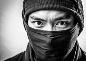headshot of ninja with east asian eyes looking to the right, sneaky, stealthy