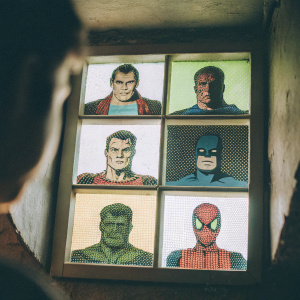 Grid of retro pixel art heroes. Iron Man, Captain America, Superman, Spider-Man, Thor, Frankenstein's Monster, Batman, and Hulk. Bright, colorful vintage aesthetic
