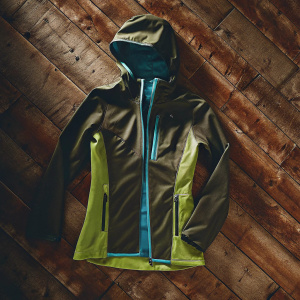 Women's Ortovox Lavarella jacket, vibrant green with blue trim. Modern, sporty design with hood and zipper closure. Athletic wear.