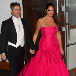 Simon Cowell and Lauren Silverman attending the glamorous Met Gala in New York City. Simon in a sharp tuxedo, Lauren in a stunning ball gown.