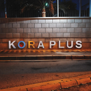 Kora Plus logo, featuring bold Paladins font, against a sleek, modern backdrop. List of alphanumeric characters and symbols displayed prominently. Clean, contemporary design with vibrant elements.