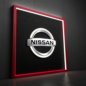 Nissan's sleek new logo. Bright silver emblem against a bold black background, framed by a vibrant red border.