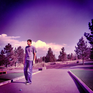 Michael Phelps in a casual outfit. Gray t-shirt and jeans. Outside at a park.