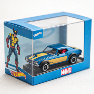 High-resolution image of a Hot Wheels Marvel character car. Blue packaging with clear window display. Wolverine figure in action pose. Light background.