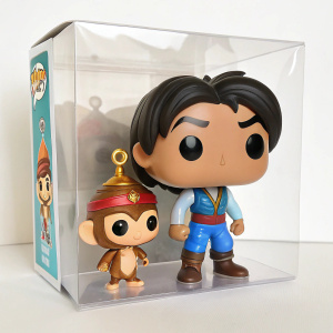 Aladdin and Abu, detailed figurines in a transparent box. Pop vinyl style packaging, resembling movie characters.