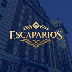 Glamorous logo design for 'ESCAPARIOS'. Bold, elegant font in gold on a rich, dark blue background.