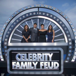 Eva Longoria, George Lopez, Yvette Nicole Brown, and Ashley Graham are seen in formal wear at a game show set. They are ready to compete in a lively episode of 'Celebrity Family Feud'.