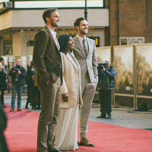 Nicholas Hoult, Glenis Brown, and Roger Hoult at the London Film Festival premiere of Tolkien. Red carpet event, movie poster backdrop.