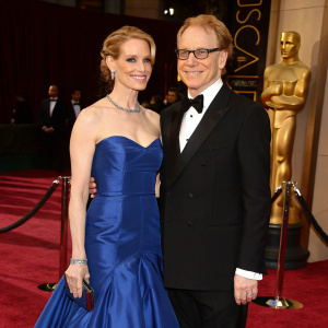 Bridget Fonda and Danny Elfman at the Academy Awards ceremony. Bridget Fonda in a stunning blue gown, Danny Elfman in a black tuxedo.