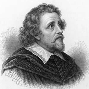 Black and white engraving of Inigo Jones, renowned English architect. He is depicted in a concerned expression with detailed features, curly hair, and a prominent jawline. Wearing a dark ornate garment and a ruff-like collar. Created during the 19th century.