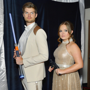 Jim Chapman and Tanya Burr at the star-studded gala. They are dressed in formal attire, standing against a black backdrop.