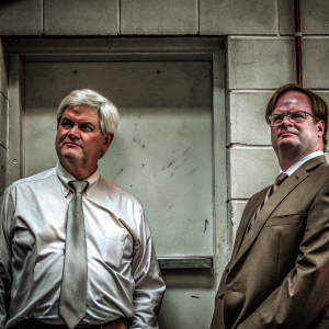 Unstyled photograph of Newt Gingrich and Dwight Schrute. Newt in a neatly pressed shirt on the left, Dwight in a rumpled brown suit on the right. Both showing their faces and upper bodies.