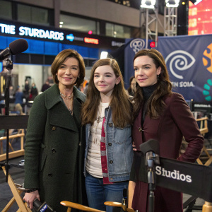 Julianne Nicholson, Abigail Breslin, and Juliette Lewis in a bustling studio setting. Casual and semi-formal outfits. Microphones and director's chairs in foreground. Studio logos and banners in background.