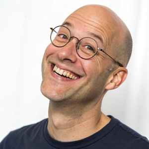 Cartoony character design. Bald man with glasses and a friendly smile. Set against a solid white backdrop.