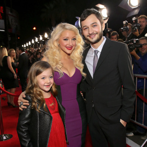 Christina Aguilera, Max Bratman, Summer Rain Rutler, and Matthew Rutler at a Hollywood movie premiere. Red carpet event with flashing cameras and fans