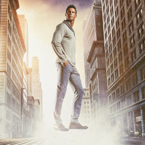 Cristiano Ronaldo, Portuguese soccer star, poses for a magazine cover. He's dressed in a casual, stylish outfit. Urban cityscape backdrop