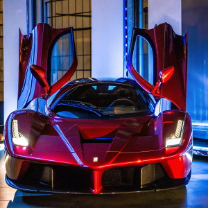 High-end photo of a red Ferrari LaFerrari concept car with angular wings and sleek body. Simple white background