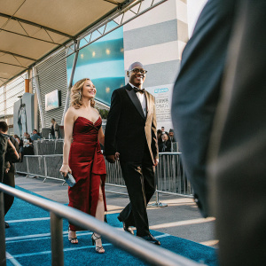 Scarlett Johansson and Samuel L. Jackson walking the red carpet at The Spirit premiere. Vibrant promotional backdrop with event logos