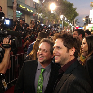 Larry Guterman and Jamie Kennedy at Son of the Mask premiere. Crowded, vibrant atmosphere. Numerous photographers and camera equipment around.
