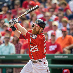 Adam LaRoche, baseball player, in intense batting stance. Clear photo showing number 25 on his jersey. Crowd blurry in background, mostly wearing red.