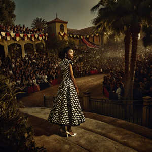 Skai Jackson, attending the BET Awards, wearing a black and white polka dot dress. Crowded outdoor scene with diverse crowd and vibrant decorations.