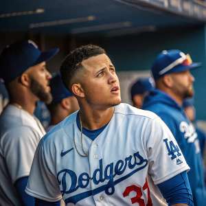Realistic photo of Manny Machado at Dodger Stadium. Wearing Dodger blue jersey. Surrounded by other players in uniform. Focused on a play with blurred dugout in background.