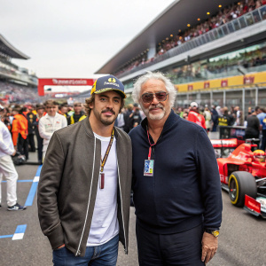 Fernando Alonso and Flavio Briatore at the Formula 1 Paddock. Fernando is in a casual outfit. Crowded event setting.