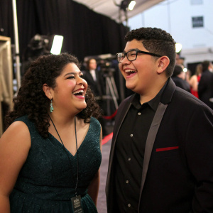 Raini Rodriguez and Rico Rodriguez, siblings, attending the SAG Awards. Casual attire, laughing together in backstage area.