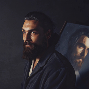A charcoal drawing of Khal Drogo. Dark, gritty style with harsh shadows. Focus on face, intricate beard detailing. Plain black backdrop