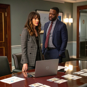 Lindsay Sloane and Dar Rollins, both standing in a conference room. Laptop and business cards on the table behind them.