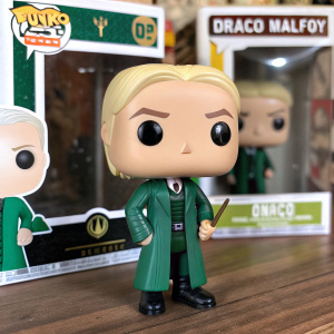 Draco Malfoy Funko Pop! Vinyl figurine, in green Hogwarts robes, standing boldly with Pop! logo and character name, packaged