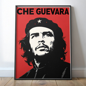 Che Guevara's iconic face on a red, poster-sized print. His features in stark black and white contrast. Bold, powerful text at the top.