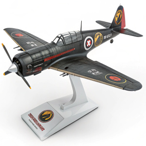 A detailed model of the Netherrealm fighter plane from Mortal Kombat, displayed on a sleek white stand. Logos and branding visible.