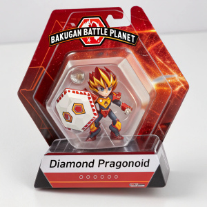 A Bakugan Battle Planet Diamond Dragonoid figurine package. Vibrant red, orange, and white design. Clear plastic window showcasing the sealed figurine and character in action. Warning label and text visible.