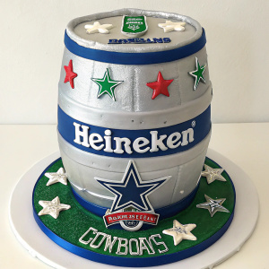 Custom Heineken keg cake decorated with Dallas Cowboys team logos and branding.