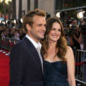 Gabriel Macht and Jacinda Barrett at the premiere event. Red carpet, flashing cameras, crowd in the background