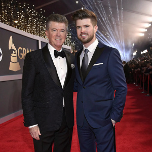 Alan Thicke and Carter William Thicke, father and son, walking the red carpet at the Grammy Awards. Formal attire, festive backdrop.
