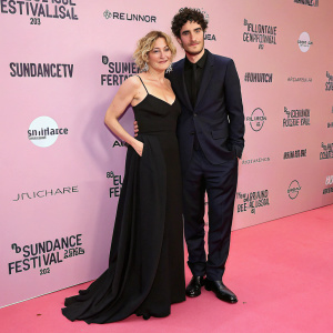 Valeria Bruni Tedeschi and Louis Garrel. Formal attire. Pink carpet at Sundance Film Festival. Valeria in elegant black gown. Louis in dark suit.